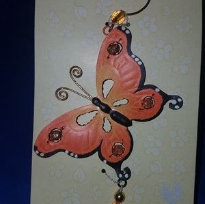 Orange butterfly metal wall decor.